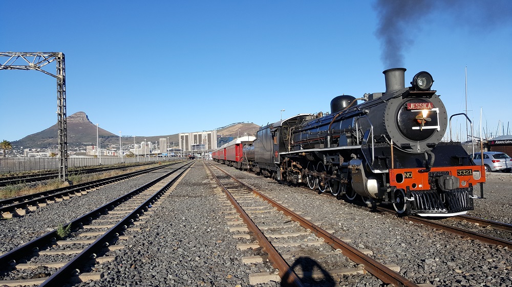 Steam engine named "Jessica" with Lions Head and Signal Hill in the background