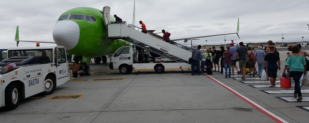 Passengers boarding a kulula plane parked at Cape Town International Airport (CPT)