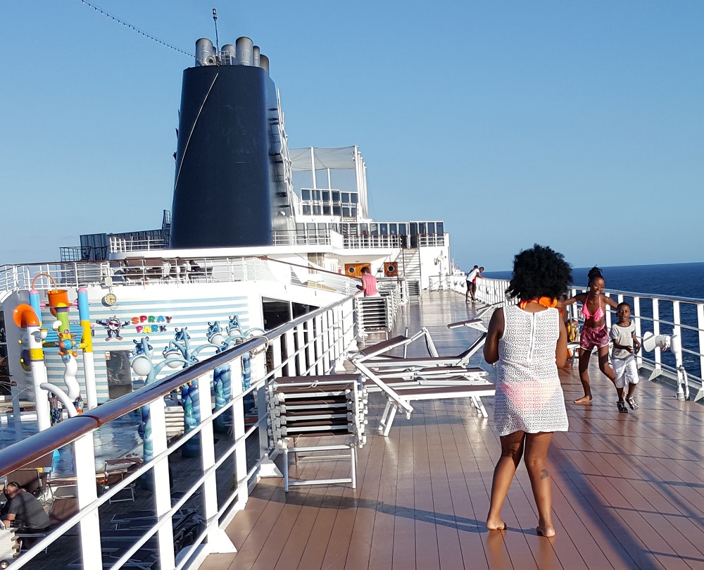Posing for a photo on the MSC Sinfonia cruise ship's twelth deck track