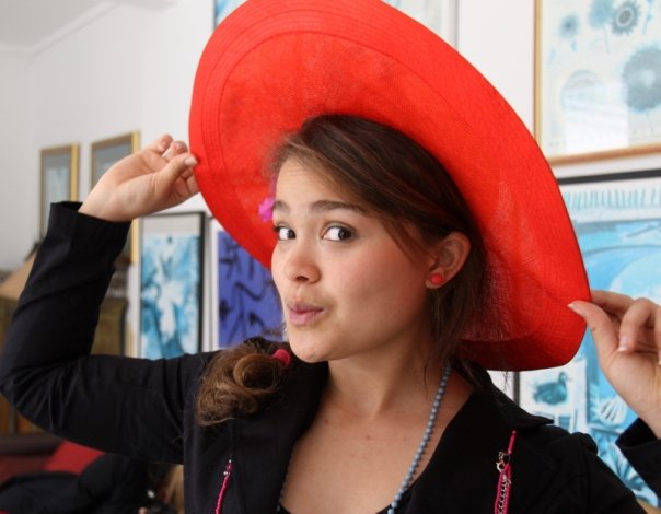 Kirsten modelling a red hat